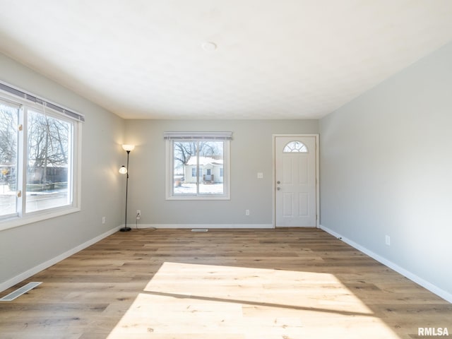 entrance foyer with visible vents, light wood-type flooring, and baseboards