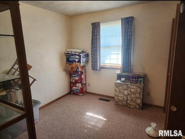 interior space featuring carpet flooring, visible vents, and baseboards