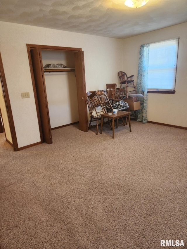 dining space featuring carpet floors and baseboards