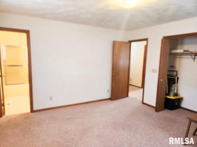 unfurnished bedroom with carpet, a closet, and baseboards