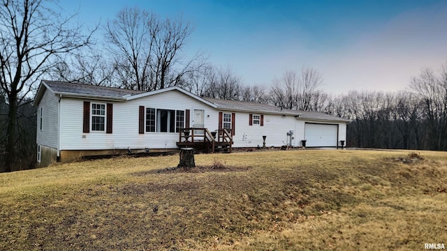 view of front of home featuring an attached garage and a front lawn