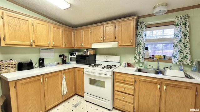kitchen featuring white gas range, light floors, under cabinet range hood, a sink, and black microwave