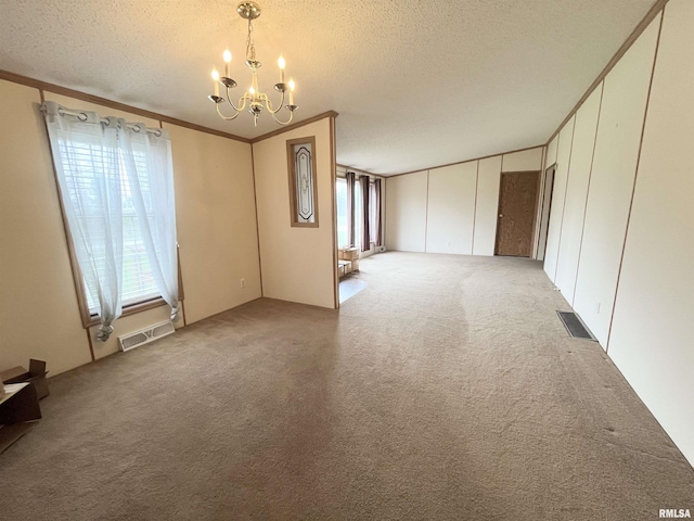 unfurnished room featuring visible vents, a chandelier, crown molding, and light colored carpet