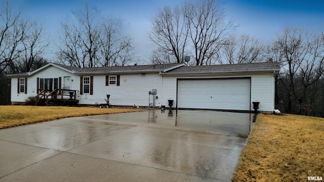 ranch-style home with a garage, driveway, and a front lawn