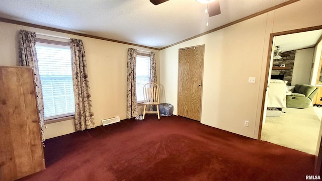 unfurnished bedroom with carpet flooring, visible vents, crown molding, a fireplace, and lofted ceiling