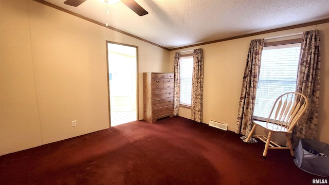 unfurnished room with crown molding, carpet flooring, a textured ceiling, visible vents, and ceiling fan