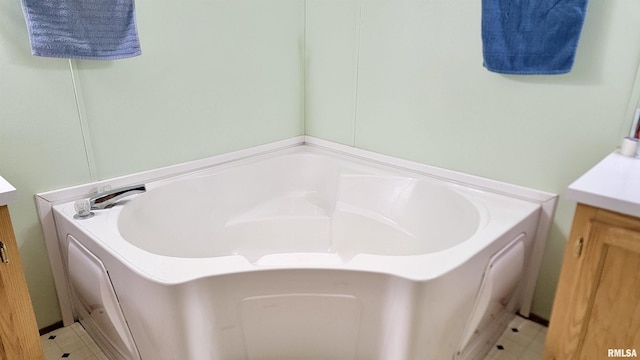 full bathroom featuring a bath and vanity
