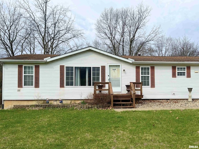 back of property featuring a lawn