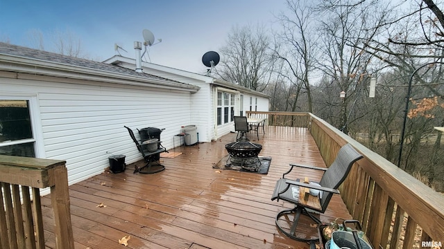wooden deck with a fire pit