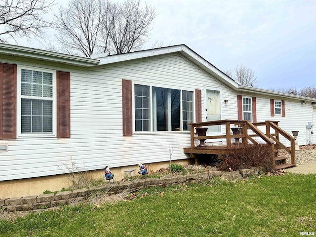 view of front of property featuring a front yard and a deck