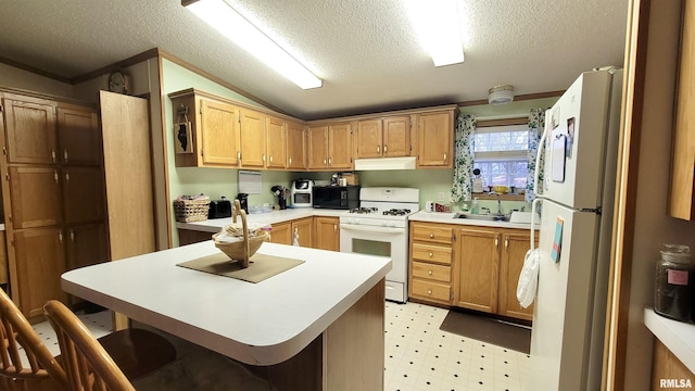 kitchen featuring light countertops, white appliances, light floors, under cabinet range hood, and a sink