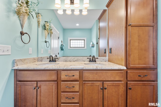 bathroom featuring a sink and double vanity