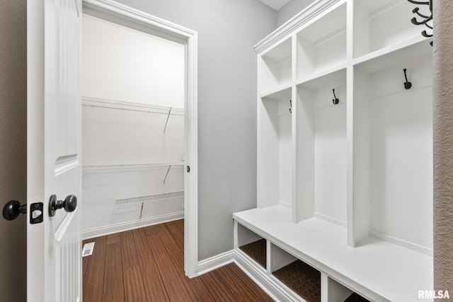 mudroom featuring dark wood-style floors and baseboards