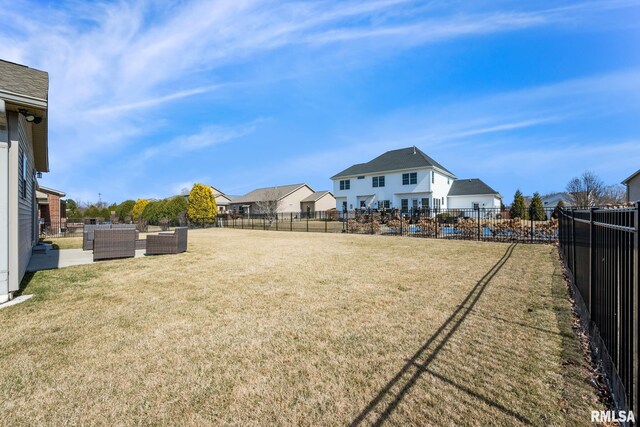 view of yard with an outdoor living space, a fenced backyard, and a patio