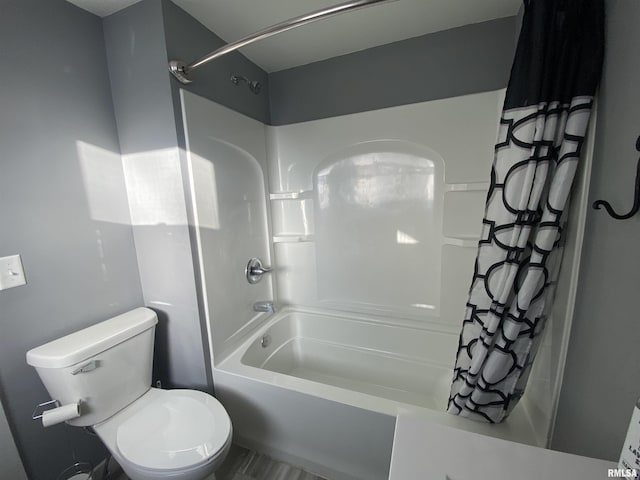 full bath featuring toilet and shower / tub combo with curtain