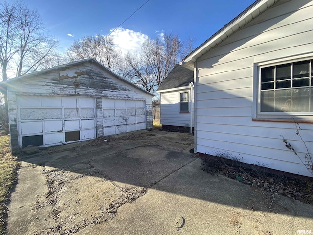 view of property exterior featuring a garage and an outbuilding