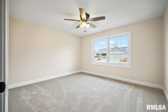 unfurnished room featuring ceiling fan, carpet floors, visible vents, and baseboards