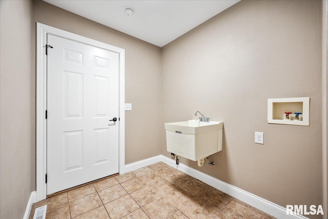 clothes washing area featuring laundry area, light tile patterned floors, baseboards, visible vents, and hookup for a washing machine