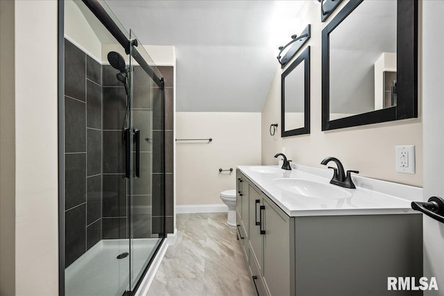 full bath with marble finish floor, a sink, a shower stall, and double vanity