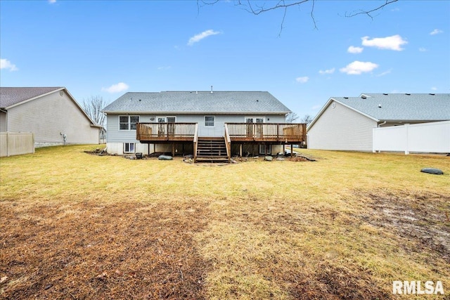 back of property featuring a yard, fence, and a wooden deck