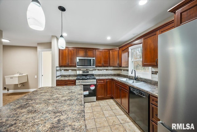 kitchen with backsplash, stainless steel appliances, a sink, and light tile patterned flooring