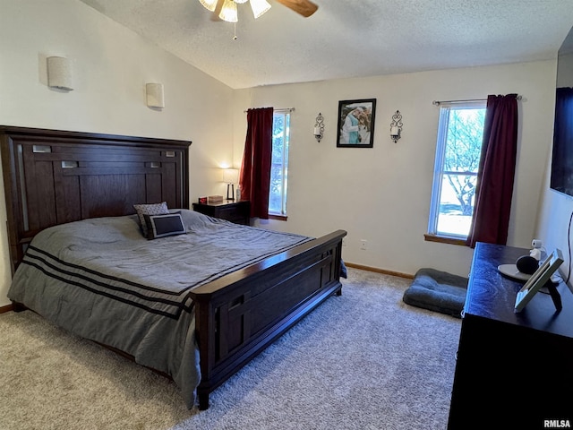 bedroom with lofted ceiling, light carpet, a textured ceiling, and baseboards