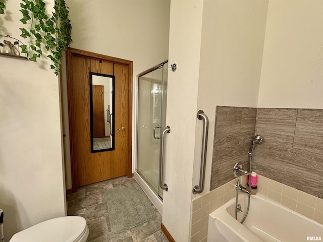 bathroom featuring a stall shower, stone finish floor, toilet, and a bathing tub