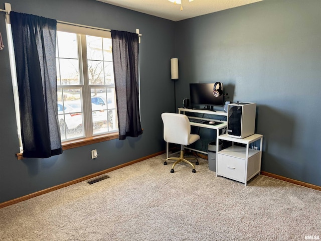 carpeted office featuring visible vents, plenty of natural light, and baseboards