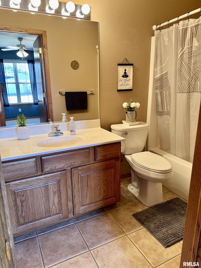 full bathroom featuring a ceiling fan, toilet, tile patterned floors, shower / bathtub combination with curtain, and vanity