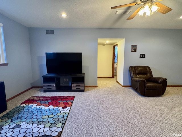 carpeted living area with baseboards and visible vents