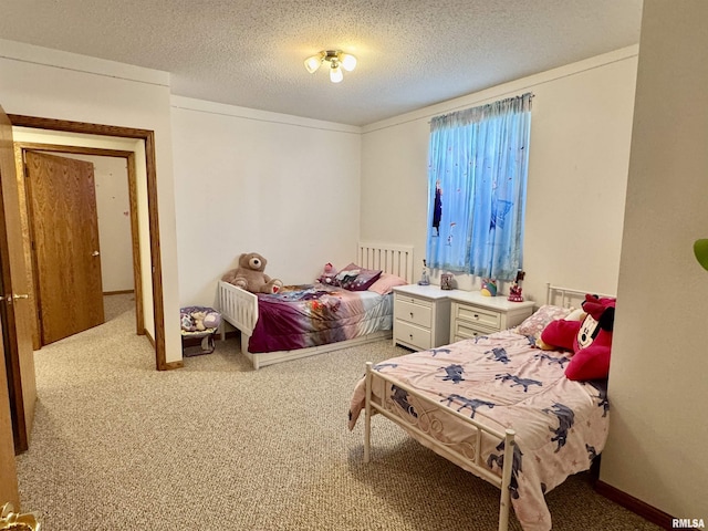 bedroom with carpet and a textured ceiling