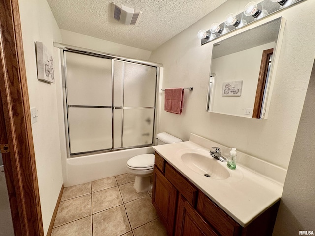 full bath featuring visible vents, toilet, vanity, a textured ceiling, and tile patterned floors