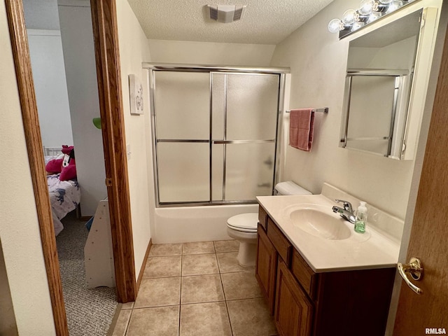 full bath featuring a textured ceiling, tile patterned flooring, toilet, visible vents, and vanity