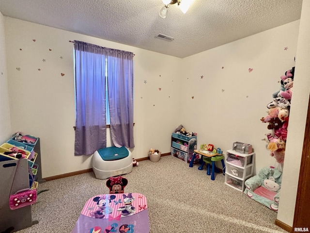 game room featuring carpet floors, visible vents, and a textured ceiling