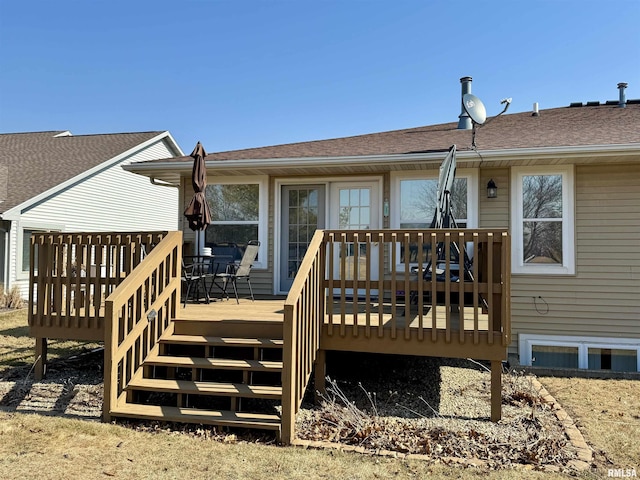 rear view of property with a shingled roof and a wooden deck