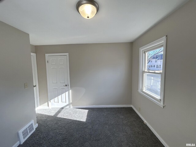 unfurnished room with visible vents, baseboards, and carpet