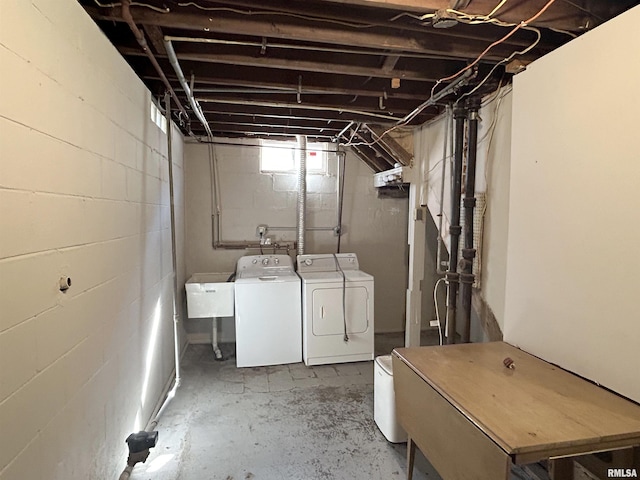 below grade area featuring washer and dryer and a sink