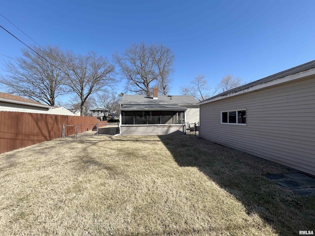 view of yard with fence and a sunroom