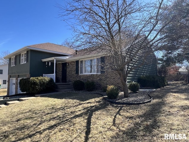 tri-level home featuring brick siding