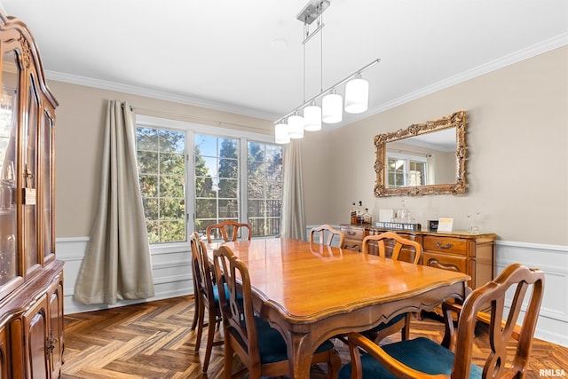 dining room with a wainscoted wall and ornamental molding