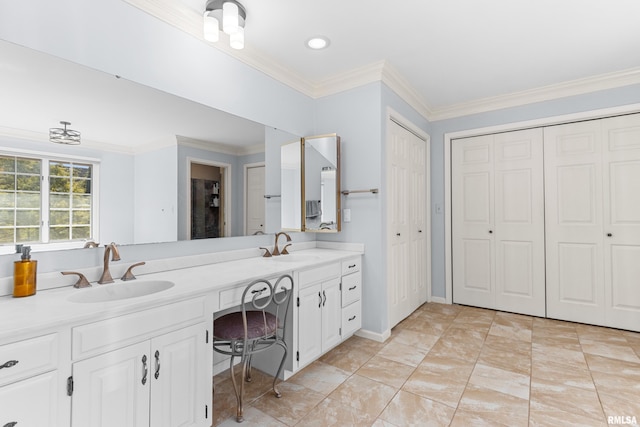 bathroom with a closet, ornamental molding, double vanity, and a sink