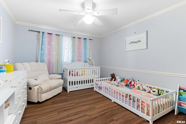 bedroom with ceiling fan, a crib, wood finished floors, and ornamental molding