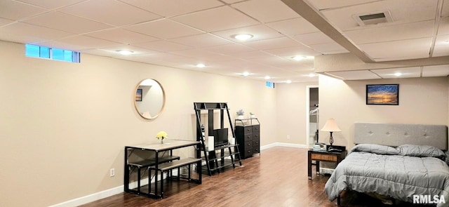 bedroom featuring a paneled ceiling, dark wood-style floors, visible vents, and baseboards