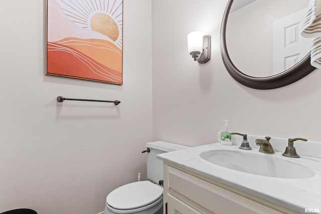 bathroom with toilet and vanity