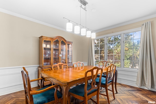 dining area featuring a wainscoted wall and crown molding