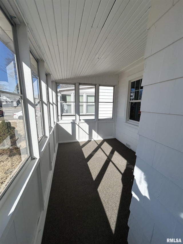 unfurnished sunroom with wood ceiling and visible vents