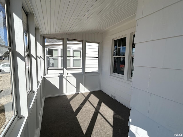 unfurnished sunroom with visible vents and wooden ceiling