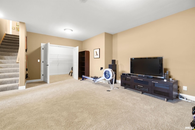 exercise area featuring carpet and baseboards