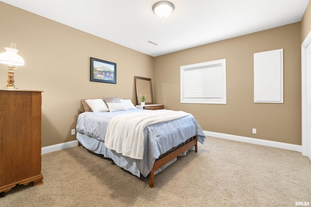 bedroom featuring a closet, visible vents, baseboards, and carpet flooring