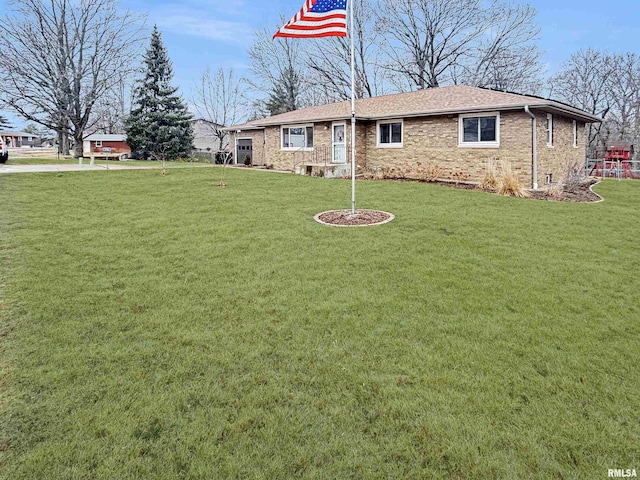 view of front of house featuring a front yard and brick siding